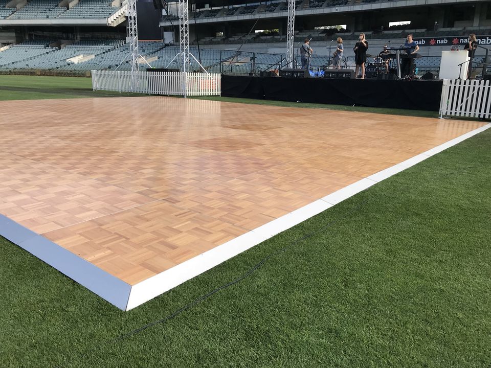Parquetry dance floor with white edging on grass