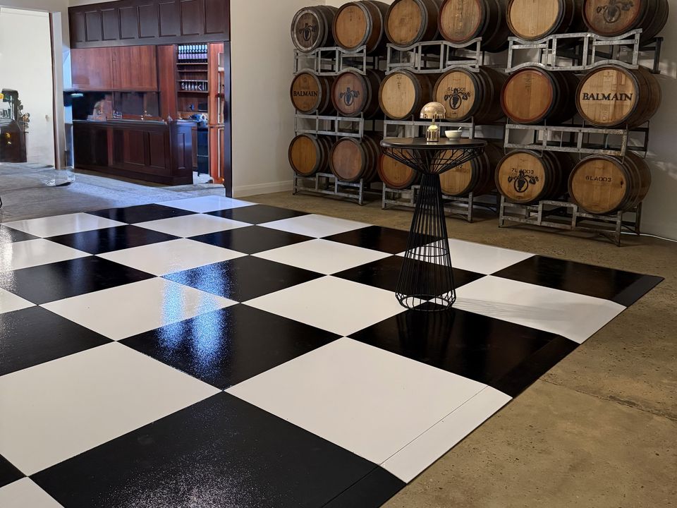 Black and White Check dance floor in a room lined with wine barrels
