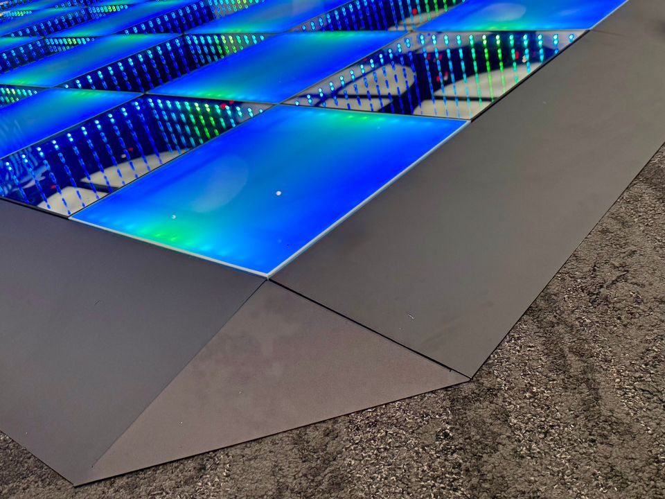 Close view of the sloped edge of a Frosted and Infinity combined LED dance floor, showing the edge gradient