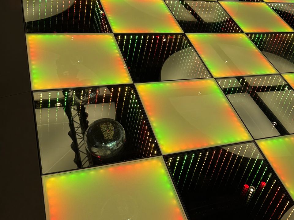 Frosted and Infinity combined LED dance floor lit yellow, green and orange
