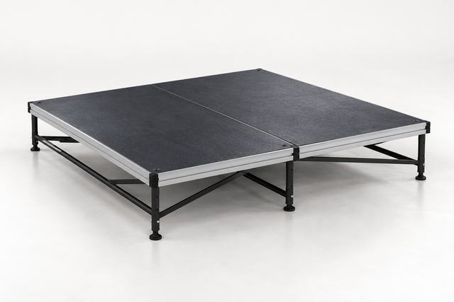3D render of a small square black platform on a steel frame with no skirt, on a plain light floor