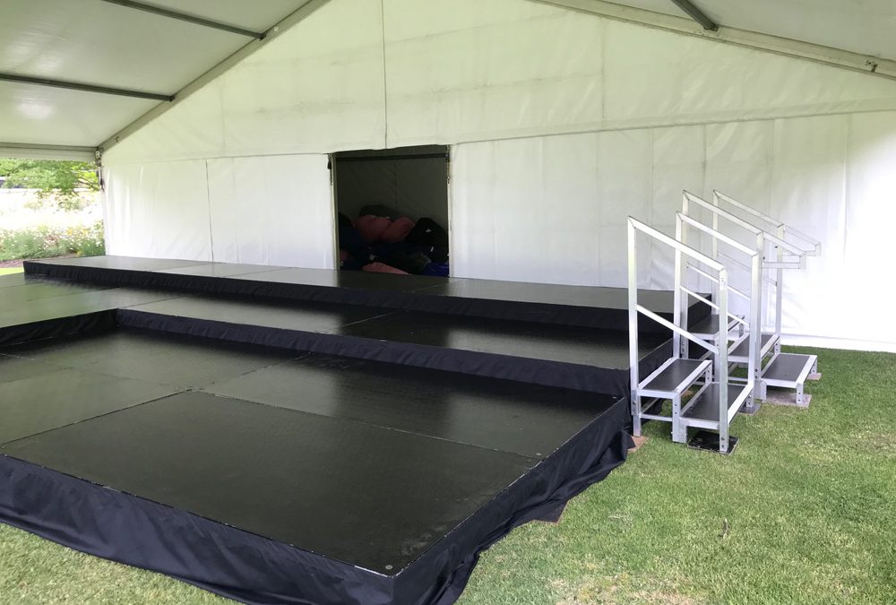 Stage on uneven ground under marquee