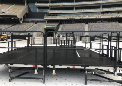 Stage with guard rails