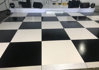 White gloss stage and checker board dance floor.