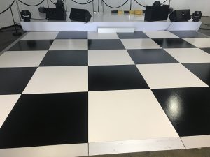 White gloss stage and checker board dance floor.