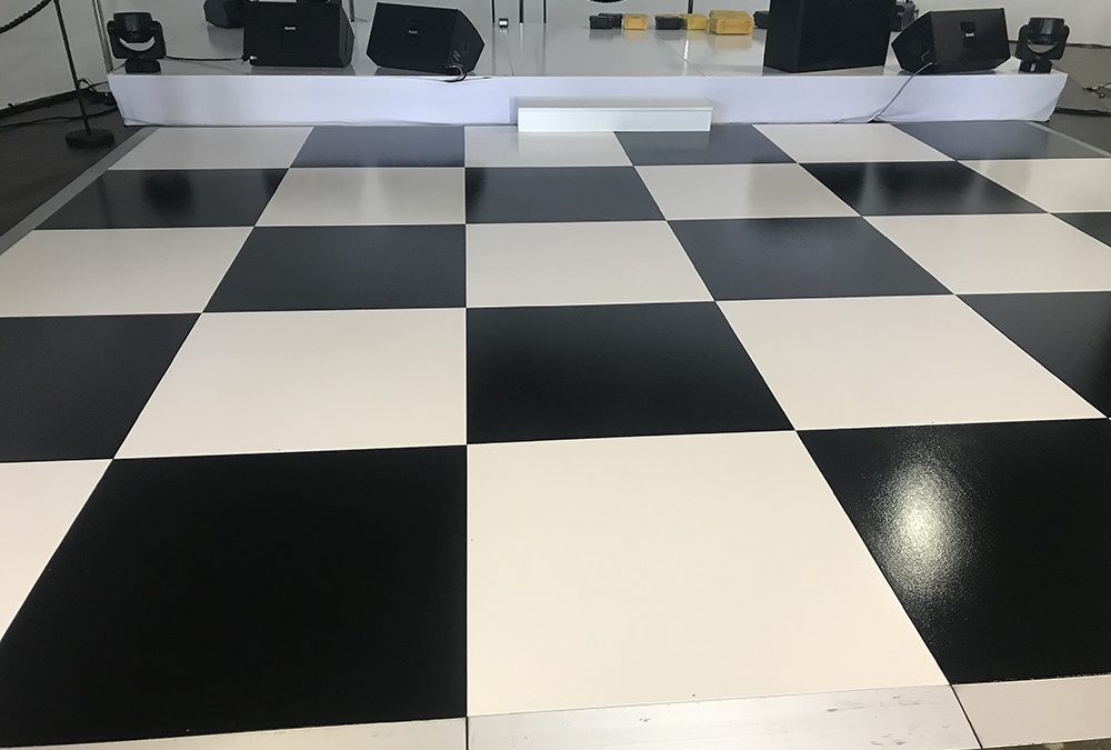 White gloss stage and checker board dance floor.